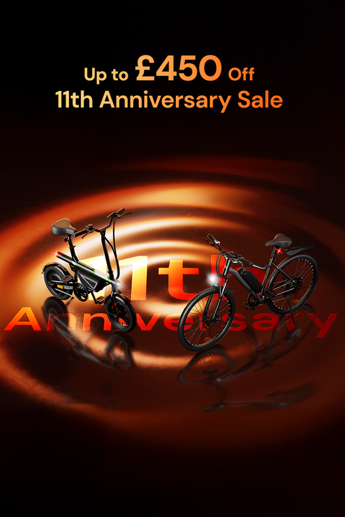 Promotional banner for an 11th Anniversary Sale featuring two electric bikes with glowing orange lighting effects and text offering up to £450 off.