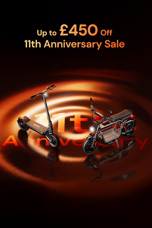 This promotional banner for an 11th Anniversary Sale features two electric scooters displayed against a warm, swirling golden background with offers of up to £450 off.