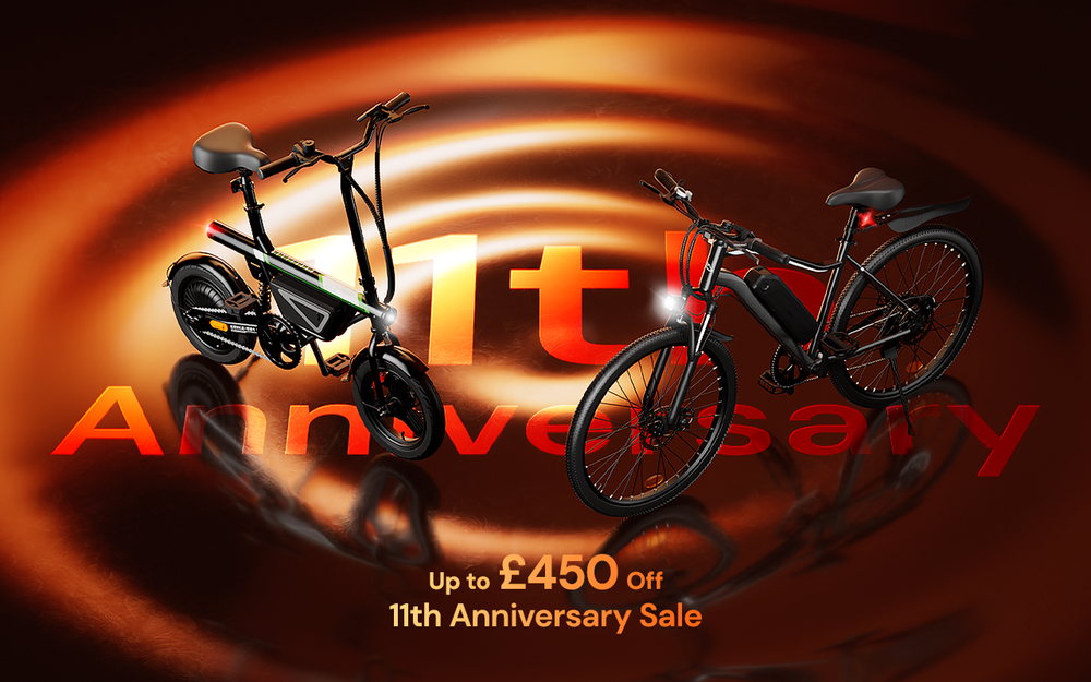 This promotional image features two electric bikes on a golden, rippled background to advertise an 11th Anniversary Sale with discounts of up to £450.