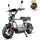 Studio shot of a grey DX5 electric scooter moped with a white background, featuring an inset graphic of a black storage bag popping out of a white gift box with a gold ribbon.