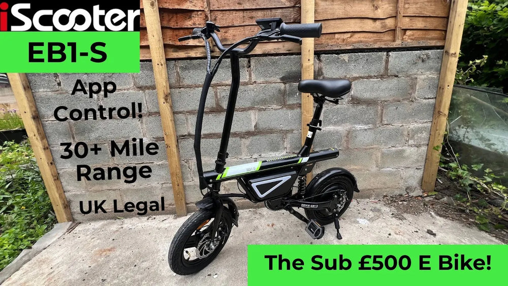 Promotional graphic featuring a compact black iScooter EB1-S electric bike parked outdoors against a brick wall, with text highlighting its '30+ Mile Range' and 'UK Legal' status.