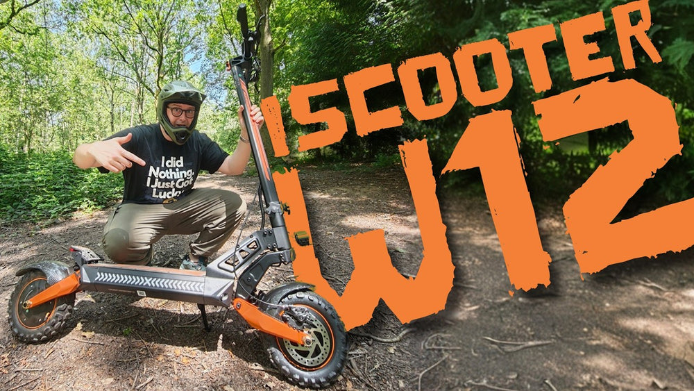 YouTube-style thumbnail featuring a rider posing beside the iScooter W12 electric scooter on a wooded trail. Large orange text reading 
