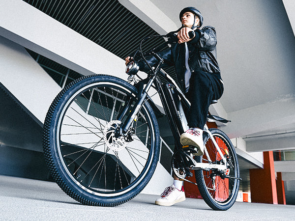 Rider on the M50 electric bike showcasing urban commuting performance, comfort, and modern design.