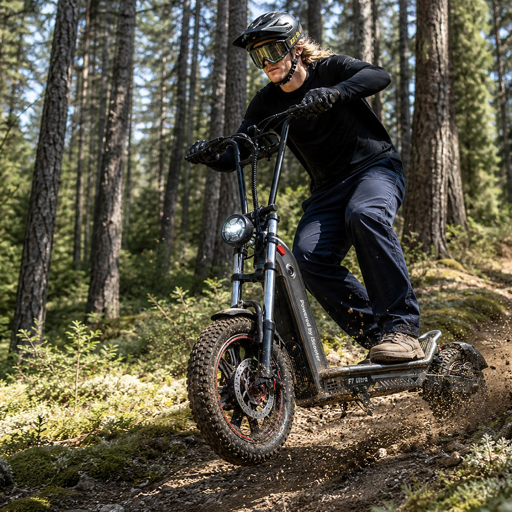 Rider wearing a helmet and protective eyewear navigating the iScooter F7 Ultra electric scooter along a rugged forest trail. Equipped with wide off-road tires, front suspension, and a powerful headlight, the scooter delivers stable handling and confident performance on uneven terrain and outdoor adventures.