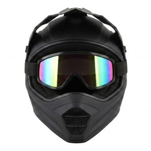 Frontal view of a matte black full-face dirt bike helmet fitted with tinted, rainbow-iridescent goggles over the eye port, showing the top visor peak and mesh chin guard vent.