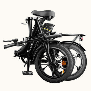 Side profile of a black folding electric bike with a step-through frame, compact wheels, rear hub motor, integrated battery, and adjustable seat displayed on a transparent background. The image showcases the bike's left side, highlighting its portable, urban commuter design.