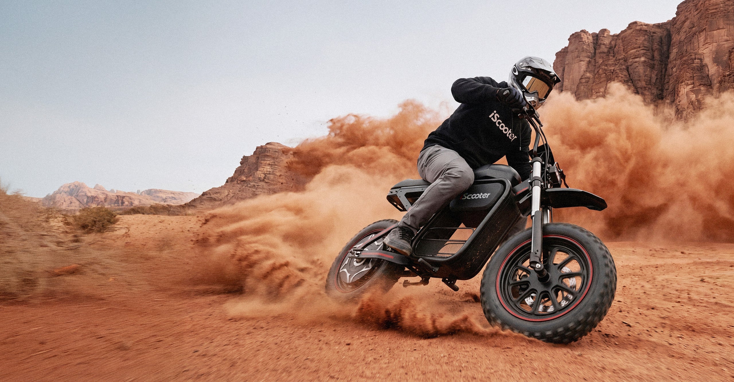 DX5Max electric scooter riding through desert dust