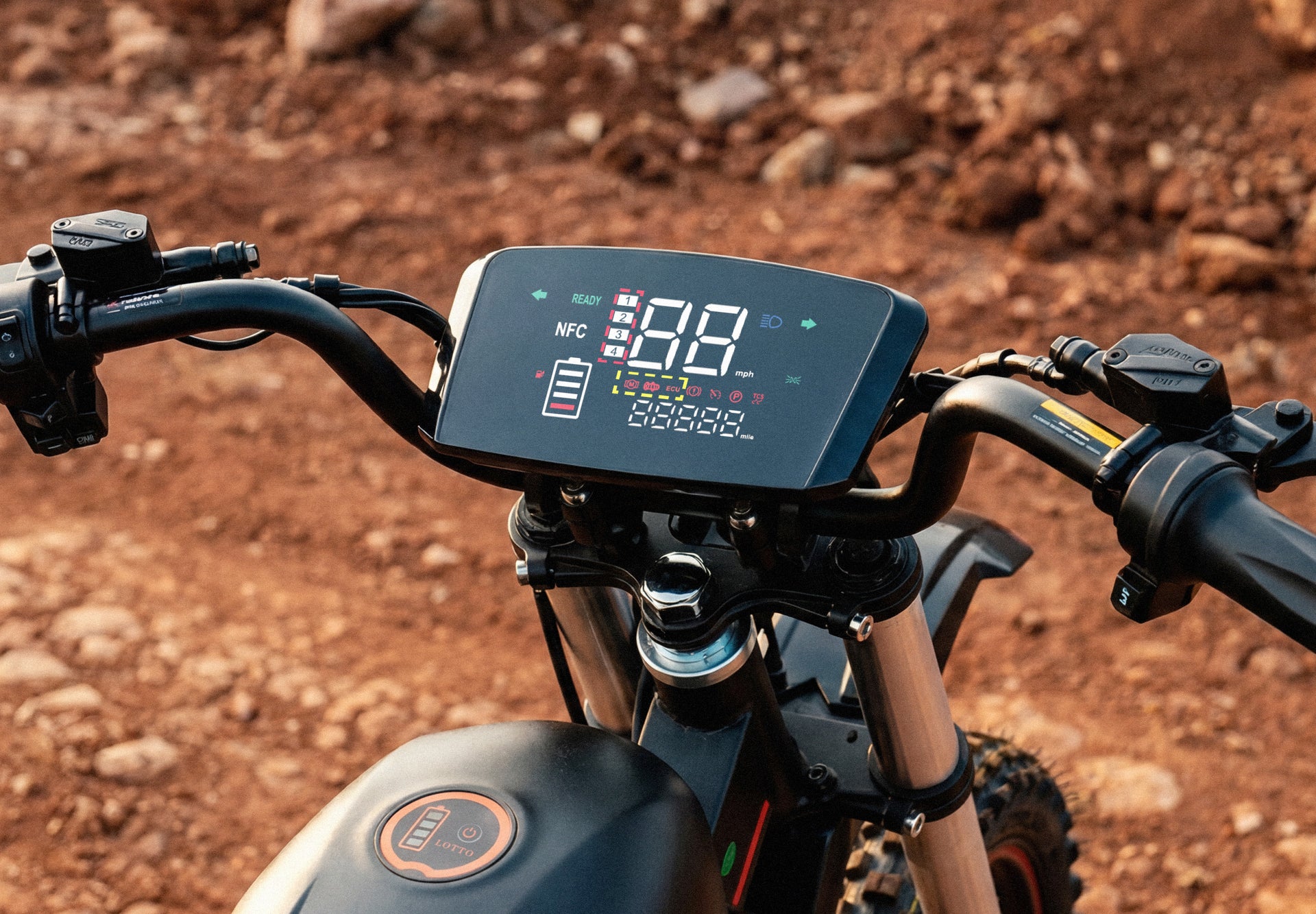 Wide-format close-up of the iScooter DX5 Max electric bike handlebars and digital dashboard. The large display shows speed, battery level, riding mode, and status indicators, while the front suspension and upper frame are visible below. Set against a rugged dirt trail backdrop, the image highlights the bike’s modern cockpit design and rider information system.