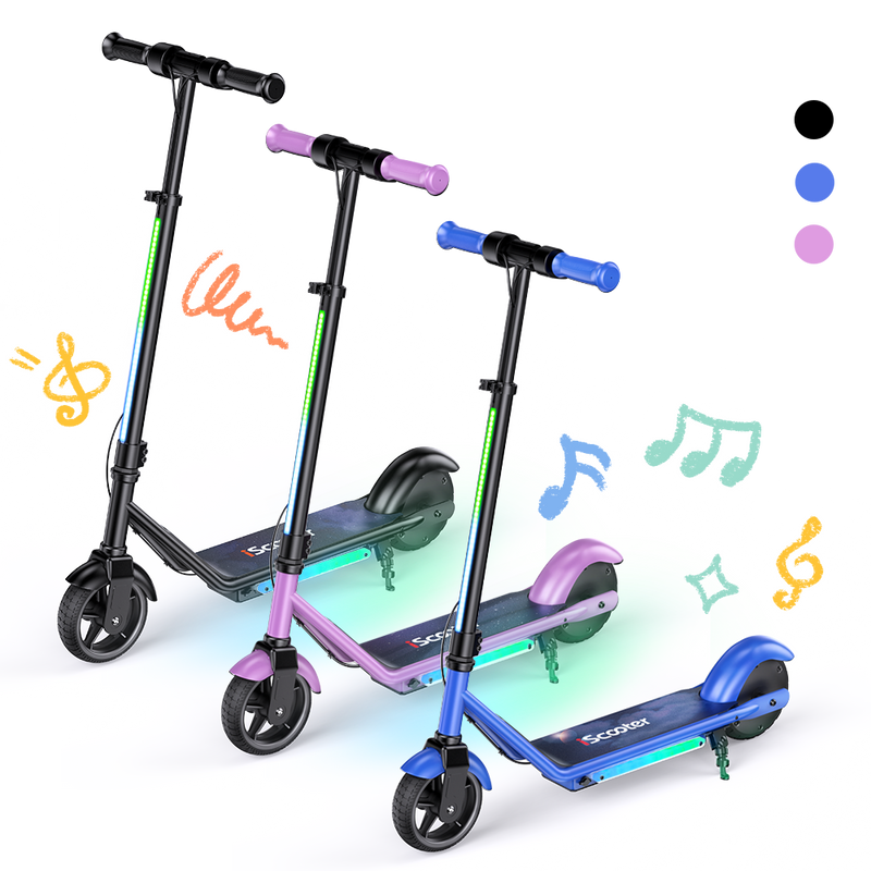 Three IK3 Pro children's electric scooters in black, pink, and blue with glowing RGB deck lights, colorful handlebar grips, and playful music note graphics on a transparent background.