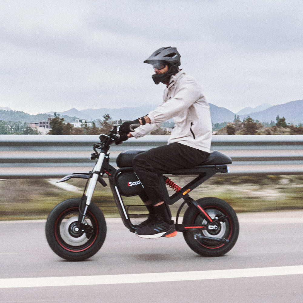 Rider cornering aggressively on the iScooter DX5 Max electric bike along an off-road trail, showcasing its fat tires, responsive handling, and rugged all-terrain performance.