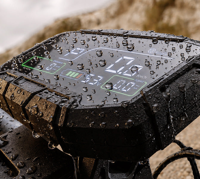 Water-resistant electric scooter digital display covered in water droplets.