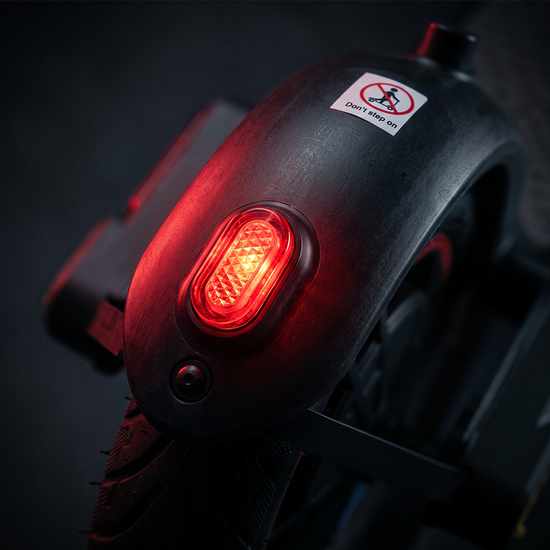 Electric scooter rear fender featuring an illuminated red LED brake light.